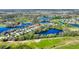 Stunning aerial view of a golf course community with homes surrounded by multiple sparkling lakes at 142 Magellan Ct, Davenport, FL 33837