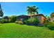 Beautiful backyard featuring a screened lanai, tropical landscaping, and lush green lawn at 142 Magellan Ct, Davenport, FL 33837