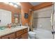 Well-lit bathroom with a granite vanity, tile shower, and ample storage space for a functional design at 142 Magellan Ct, Davenport, FL 33837