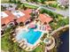 Aerial view of the community pool and recreation area with lounge chairs and lush landscaping at 142 Magellan Ct, Davenport, FL 33837