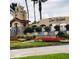 Community entrance featuring manicured landscaping, blooming flowers and water features at 142 Magellan Ct, Davenport, FL 33837