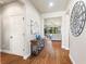 Welcoming foyer with hardwood floors and decor, offering a glimpse into the bright, open living space at 142 Magellan Ct, Davenport, FL 33837