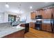 Modern kitchen featuring granite counters, stainless appliances, and hardwood floors for a sleek design at 142 Magellan Ct, Davenport, FL 33837