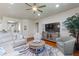 Inviting living room with hardwood floors, neutral tones, ceiling fan, and plenty of seating for relaxation at 142 Magellan Ct, Davenport, FL 33837