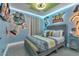 Bright 'Toy Story' themed bedroom with modern bed, stylish linens, and themed decor creates a playful atmosphere at 1520 Oak Hill Trl, Kissimmee, FL 34747