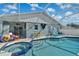 Beautiful swimming pool with a jacuzzi, surrounded by seating, within a screened lanai for outdoor enjoyment at 1520 Oak Hill Trl, Kissimmee, FL 34747