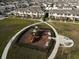 Aerial view of the community playground and picnic area amongst neighborhood homes at 1567 Dawnview Way, Kissimmee, FL 34744