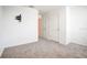 Carpeted room featuring neutral walls and two doors at 1567 Dawnview Way, Kissimmee, FL 34744