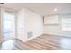 Well-lit bedroom with wood-look floors, a double door closet, a window, and a minimalist design at 1567 Dawnview Way, Kissimmee, FL 34744