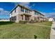 Shows the exterior of a two-story townhome with well-manicured lawn and simple landscaping at 1567 Dawnview Way, Kissimmee, FL 34744