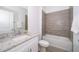 Bathroom featuring a granite countertop, bathtub and tiled floors at 1620 Cumin Dr, Kissimmee, FL 34759