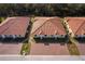 Aerial view of lovely villas featuring red tile roofs and brick paved driveways at 1623 Cumin Dr, Kissimmee, FL 34759