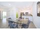 Dining area adjacent to kitchen with seating for four, white cabinets and stainless steel appliances at 1732 Pacific Rd, Kissimmee, FL 34759