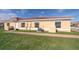 Charming exterior featuring clay tile roof, neutral colored stucco, green grass, and a paver walkway at 1732 Pacific Rd, Kissimmee, FL 34759