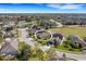 Aerial view of a home within a well-planned community, featuring manicured lawns and beautiful surroundings at 208 Almeria Way, Davenport, FL 33837