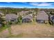 Aerial view of multiple homes with screened patios, lush landscaping, and well-maintained lawns at 208 Almeria Way, Davenport, FL 33837