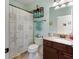 Bright bathroom featuring a vanity with a granite countertop and a shower with decorative shower curtain at 208 Almeria Way, Davenport, FL 33837