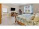 Bedroom featuring a desk, a television and a view of the attached bathroom with a soaking tub at 208 Almeria Way, Davenport, FL 33837