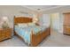 Charming bedroom features a wooden bed frame, matching nightstands, and a bright, airy atmosphere at 208 Almeria Way, Davenport, FL 33837