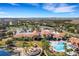 Breathtaking aerial shot showcases a community center with a resort-style pool and beautifully landscaped grounds at 208 Almeria Way, Davenport, FL 33837