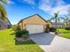 Well maintained property with manicured lawn, mature palm trees, and shrubbery at 208 Almeria Way, Davenport, FL 33837