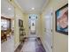 Welcoming foyer with decorative rug, neutral paint, and views to kitchen and dining at 208 Almeria Way, Davenport, FL 33837