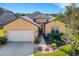 Inviting home showcasing a spacious driveway, manicured lawn, and attractive landscaping at 208 Almeria Way, Davenport, FL 33837