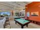 Game room with pool tables, artwork, and comfortable chairs for recreation at 208 Almeria Way, Davenport, FL 33837