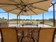 Screened-in outdoor kitchen features a stone bar, built-in grill, and seating with views of the golf course at 208 Almeria Way, Davenport, FL 33837