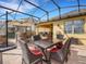 Beautiful view of the patio, which features an outdoor kitchen, dining, and living area at 208 Almeria Way, Davenport, FL 33837