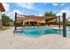 Outdoor pool with shade covering, brick pavers, and a fountain feature at 208 Almeria Way, Davenport, FL 33837