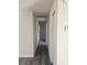 Hallway featuring wood grain floors, and access to other rooms of the house at 2209 Sw 6Th St, Ocala, FL 34471