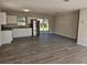 Spacious kitchen featuring stainless steel appliances, white cabinetry, and wood grain floors at 2209 Sw 6Th St, Ocala, FL 34471