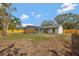 Backyard view of caged pool, covered patio and privacy fence, with lush grass at 2488 Pine Chase Cir, St Cloud, FL 34769