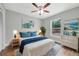 Tranquil bedroom with coastal-themed decor, featuring a comfortable bed, matching nightstands, and ample natural light at 2488 Pine Chase Cir, St Cloud, FL 34769