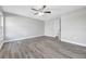 Large bedroom with wood-look floors, a ceiling fan, and an en-suite bathroom at 2488 Pine Chase Cir, St Cloud, FL 34769