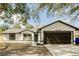 Charming single-story home featuring a two-car garage, gray roof, and well-maintained landscaping at 2488 Pine Chase Cir, St Cloud, FL 34769