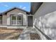 Close up view of home's front entry featuring modern front door and textured exterior at 2488 Pine Chase Cir, St Cloud, FL 34769