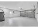 Spacious garage with epoxy floors, garage door, and access door at 2488 Pine Chase Cir, St Cloud, FL 34769