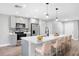 Modern kitchen with stainless steel appliances, quartz countertops, a breakfast bar, and sleek gray cabinetry at 2488 Pine Chase Cir, St Cloud, FL 34769