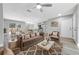 Open-concept living room featuring modern furnishings, light gray walls, and a view of the kitchen and dining area at 2488 Pine Chase Cir, St Cloud, FL 34769