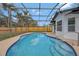 Screened-in pool area with bright blue water and concrete pool deck at 2488 Pine Chase Cir, St Cloud, FL 34769