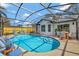 Screened-in pool area with bright blue water, patio furniture, and concrete pool deck at 2488 Pine Chase Cir, St Cloud, FL 34769