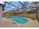 Screened-in pool area with bright blue water and concrete pool deck at 2488 Pine Chase Cir, St Cloud, FL 34769