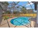 Screened-in pool area with bright blue water and concrete pool deck at 2488 Pine Chase Cir, St Cloud, FL 34769