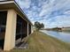 This home features a screened in patio with a picturesque view of the serene lake at 2523 Salzburg Loop, Winter Haven, FL 33884