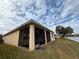 The exterior of this home features a screened in patio and a view of the lake at 2523 Salzburg Loop, Winter Haven, FL 33884