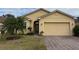 Well-maintained single-story home featuring a two-car garage and mature landscaping at 2523 Salzburg Loop, Winter Haven, FL 33884