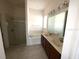 Main bathroom featuring double sinks, a soaking tub, and a separate shower at 2523 Salzburg Loop, Winter Haven, FL 33884