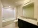 Bright bathroom featuring a shower over tub and granite vanity at 2595 Buena View Road, Kissimmee, FL 34746